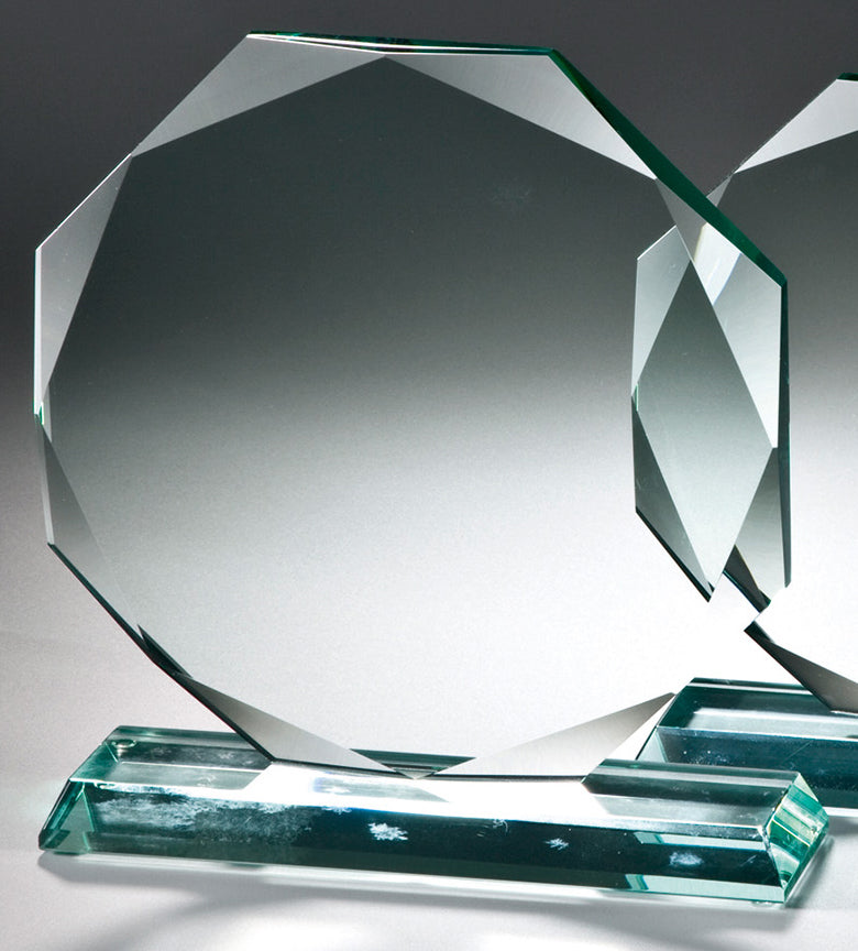 Eine klare, facettierte Glastrophäe in achteckiger Form, montiert auf einem rechteckigen Sockel aus Jade-Premiumglas, präsentiert vor einem Hintergrund mit Farbverlauf. Auszeichnungen Chemnitz 3-er Serie 154 mm - 202 mm PK765084-80-3