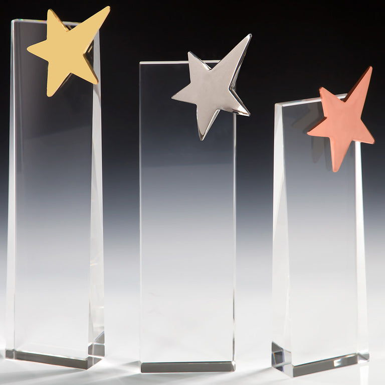 Drei klare Glasstelen in abgestufter Höhe mit je einem Stern-Emblem in Gold, Silber und Bronze. Awards Potsdam 3-er Serie von POMEKI.