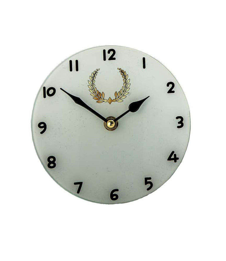 Eine runde weiße Uhr mit schwarzen Ziffern und schwarzen Stunden- und Minutenzeigern, die die Zeit als 9:10 anzeigt. Das Zifferblatt weist über der Mitte ein goldenes Kranzemblem auf, was es zu einer perfekten Trophäe-Uhr 150 mm Durchmesser oder sogar zu einer besonderen Auszeichnung macht.