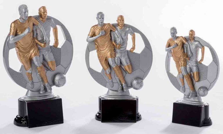 Drei Fußballtrophäen in verschiedenen Größen, jede mit zwei Spielern in Aktion auf einem sechseckigen Sockel. 3-er Serie Fußballer 160 mm – 200 mm von POMEKI.